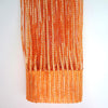 Orange boho tassel string curtain hanging vertically