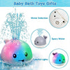 A colorful light-up whale bath toy is shown spraying water and emitting colorful lights in a bath.