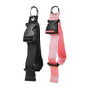 A pink adjustable travel luggage strap and belt with black buckles and silver rings.
