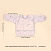 A light pink waterproof long-sleeve baby feeding smock with a decorative pattern.