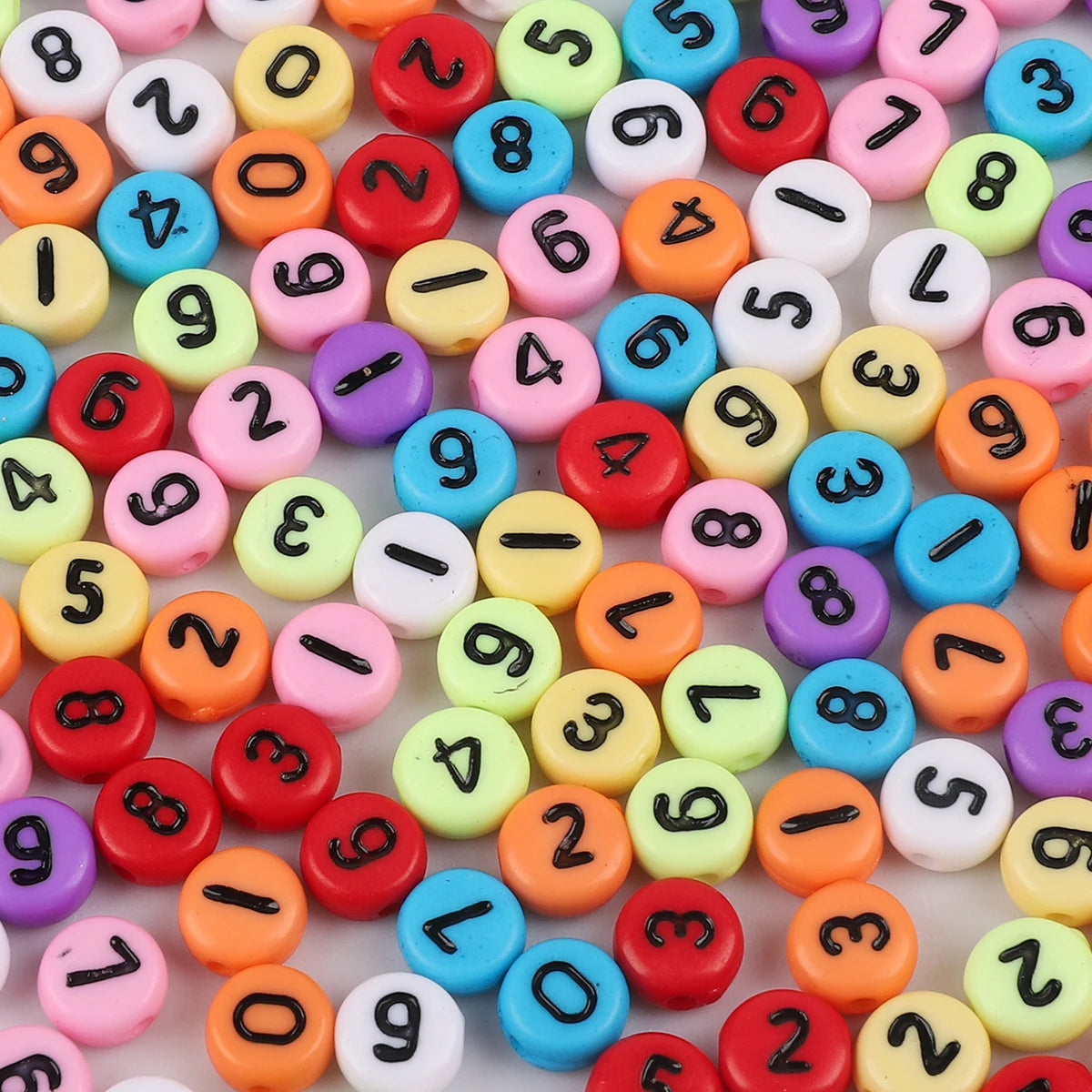 A collection of colorful acrylic letter beads in various shapes and colors for jewelry making