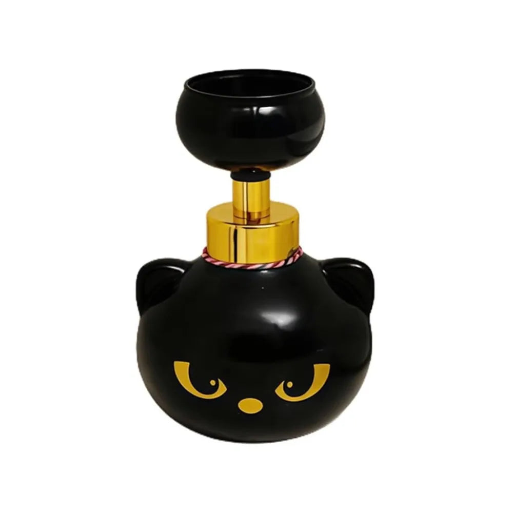 A black and gold foam soap dispenser shaped like a cat's head with ears.