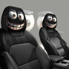 A set of two black smiley face car headrest cushion covers shown in a vehicle seat.