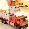 An orange diecast model truck carrying a white grocery box with fruit and vegetable parts for assembly.