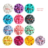 A collection of silicone crown star heart beads in various colors including white purple turquoise pink and yellow