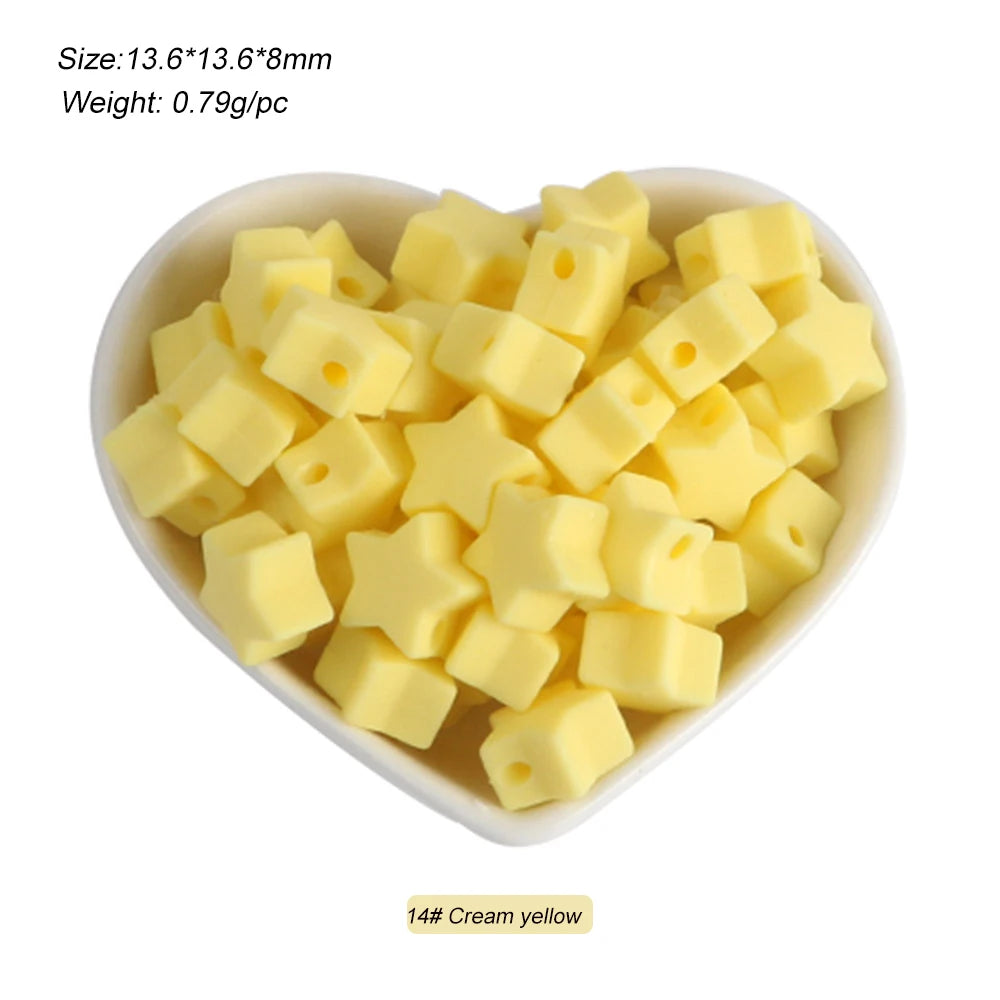 A pile of yellow silicone crown star heart beads for DIY jewelry making