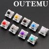 A collection of Outemu mechanical keyboard switches in various colors including black, yellow, red, purple, blue, and cyan.