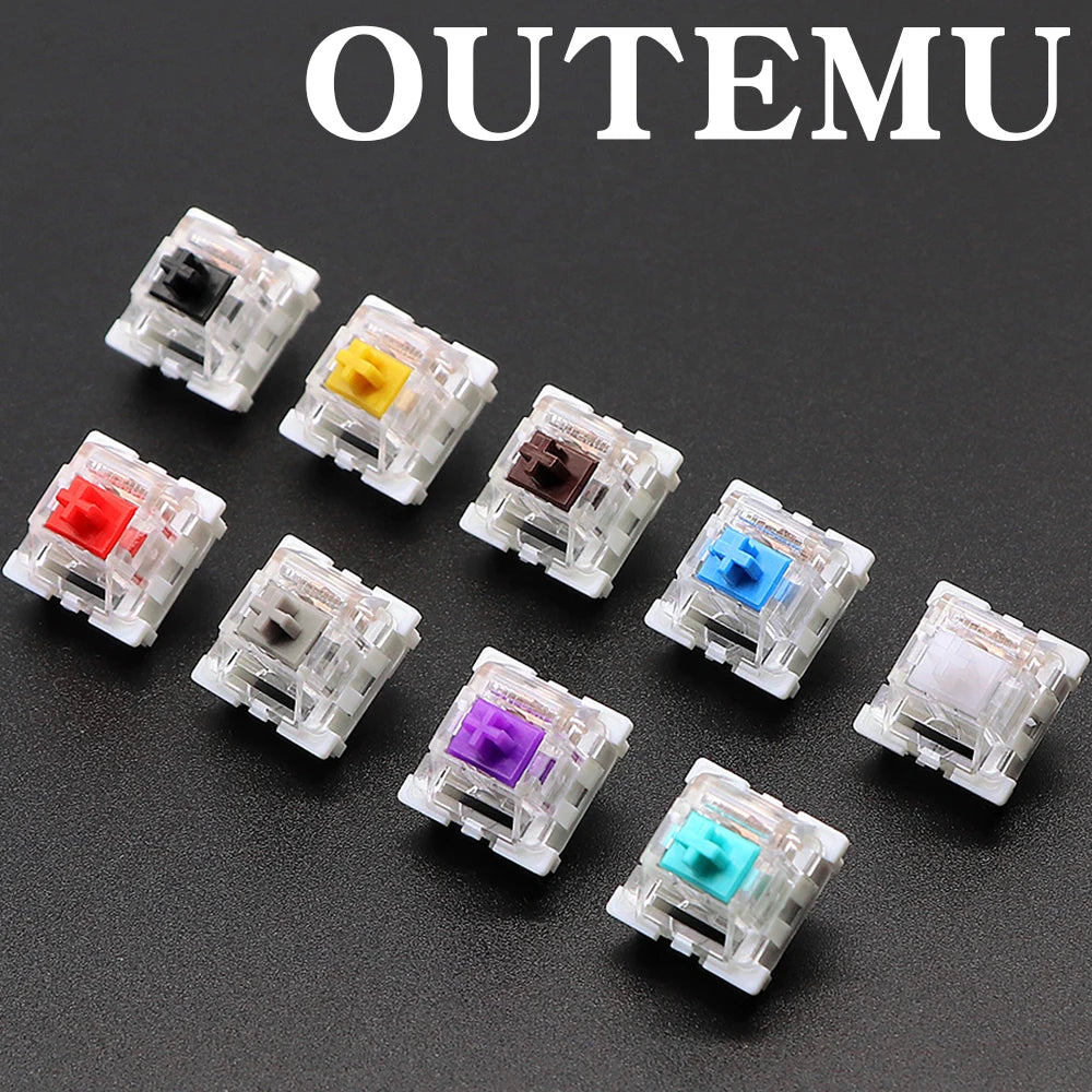 A collection of Outemu mechanical keyboard switches in various colors including black, yellow, red, purple, blue, and cyan.
