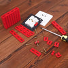 Red PVC outlet spacers and electrical components laid out on a wooden surface.