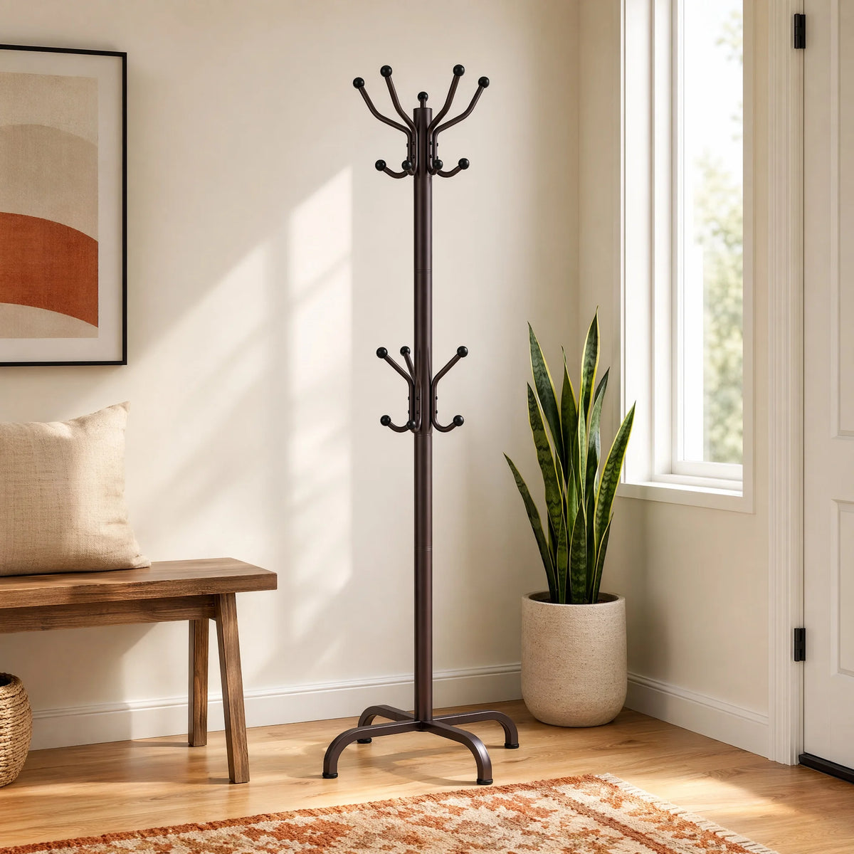 A tall, black metal coat rack with fourteen hooks stands next to a wooden bench and a potted plant in a bright room.