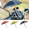 A black mini motorcycle phone umbrella with a dark canopy and silver frame, shown alongside other colored umbrellas.