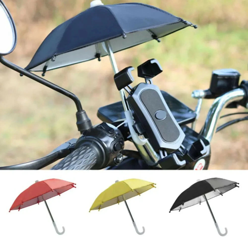 A black mini motorcycle phone umbrella with a dark canopy and silver frame, shown alongside other colored umbrellas.