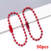 A string of red ball beads is displayed on a white background, with one bead removed.