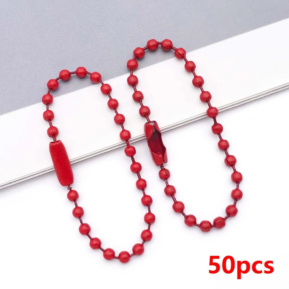 A string of red ball beads is displayed on a white background, with one bead removed.