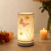 A Nordic retro USB table lamp with a fabric shade glowing warmly on a white surface.