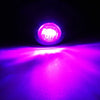 A close-up shot of a bright pink LED side marker light illuminating a purple surface.