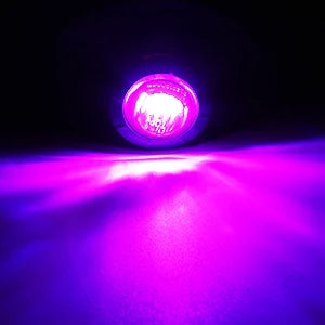 A close-up shot of a bright pink LED side marker light illuminating a purple surface.