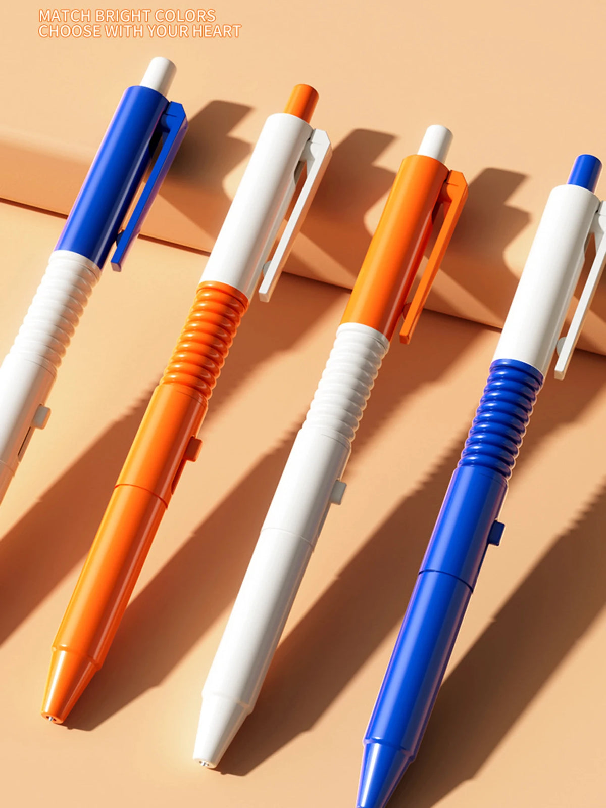 Four colored prank water gun pens displayed diagonally on a light background.