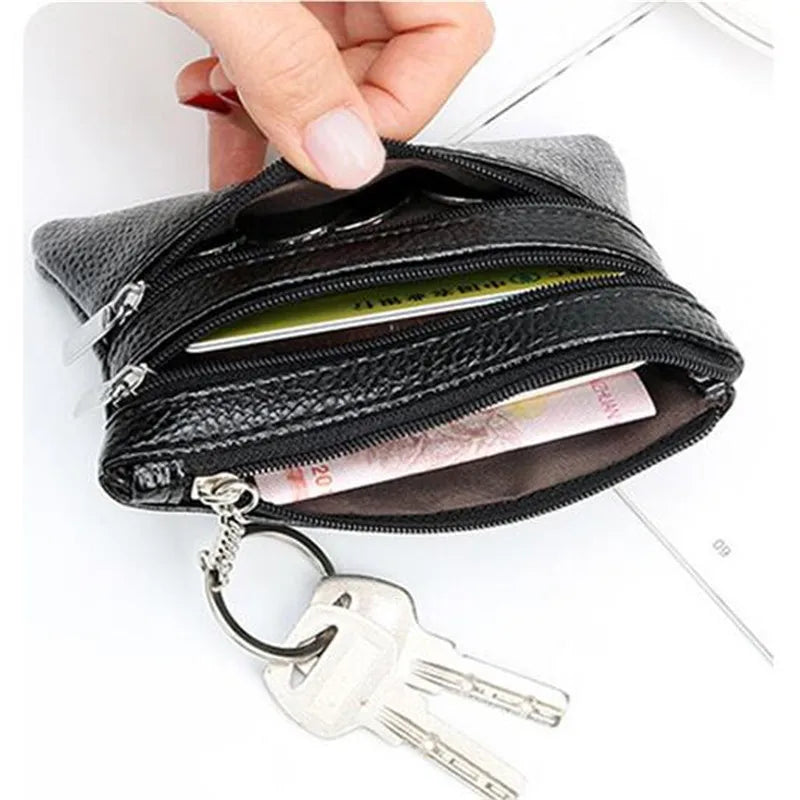 A black PU leather two-zip coin purse is shown open, with a silver key attached below it.