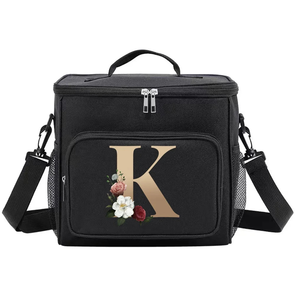 Black insulated canvas lunch bag featuring a gold letter K design and adjustable straps.