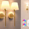 Two gold-finish rechargeable wireless wall lamps mounted on a textured wall with remote controls shown below.