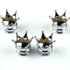 A set of four silver universal crown valve caps with decorative points.