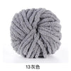A ball of gray chunky acrylic yarn used for knitting and crochet