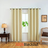 A pair of beige blackout curtains hanging in a window with a green plant visible outside.
