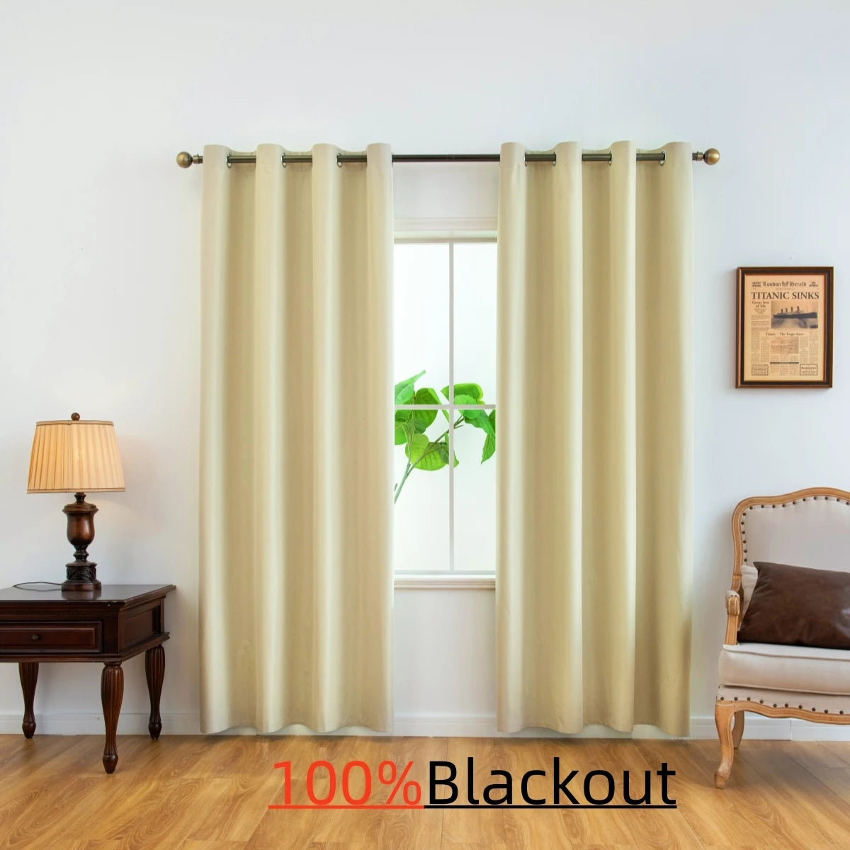 A pair of beige blackout curtains hanging in a window with a green plant visible outside.