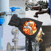 Black faucet insulation cover protecting an outdoor water tap from freezing and ice damage.