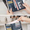 A hand holds a dark blue leather wallet with gold accents, displaying the interior and exterior.