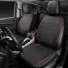 A set of black leather car seat covers installed in a vehicle interior, showing the front seats and driver's side.
