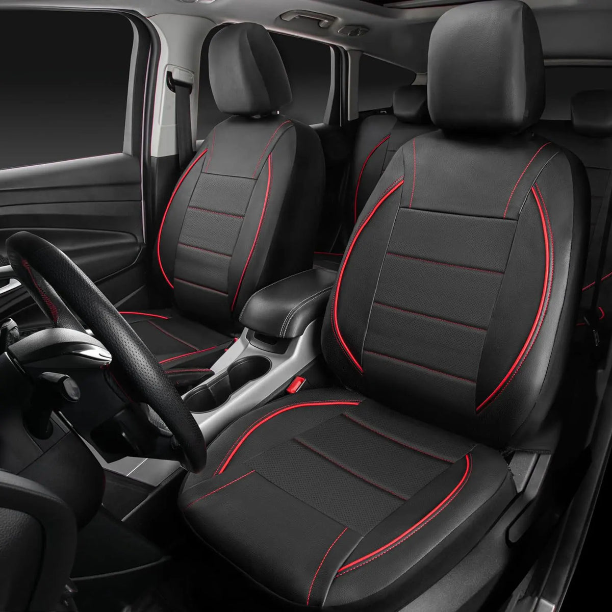 A set of black leather car seat covers installed in a vehicle interior, showing the front seats and driver's side.