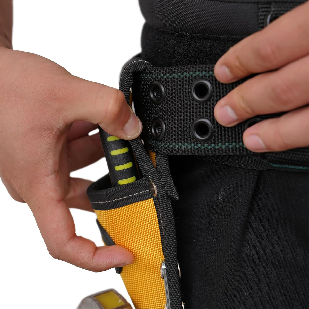 A hand is adjusting a heavy-duty plier holster with a hammer loop for a work belt.