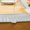 A silicone faucet drain mat is shown dripping water onto a wooden surface.