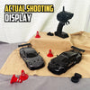 A black 4WD RC drift truck model is displayed on a tan cloth next to a black remote control and a black display stand.