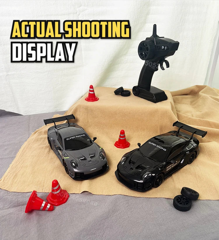 A black 4WD RC drift truck model is displayed on a tan cloth next to a black remote control and a black display stand.