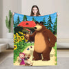 A flannel throw blanket featuring a cartoon design of Masha and Bear in a forest setting.