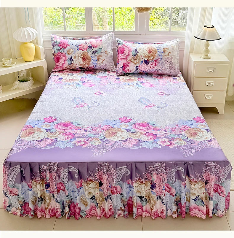 A purple floral print bed skirt and pillowcase set featuring pink, purple, and green flowers.