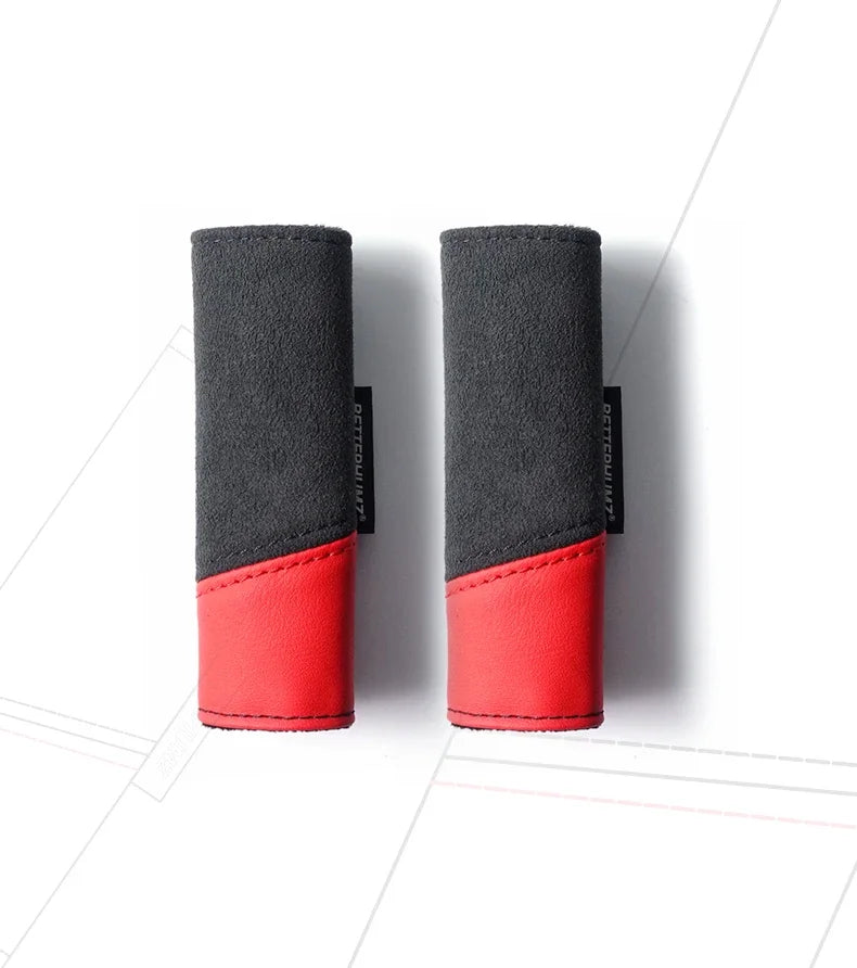 A pair of black and red Audi Alcantara grab handle protector covers with card pockets.