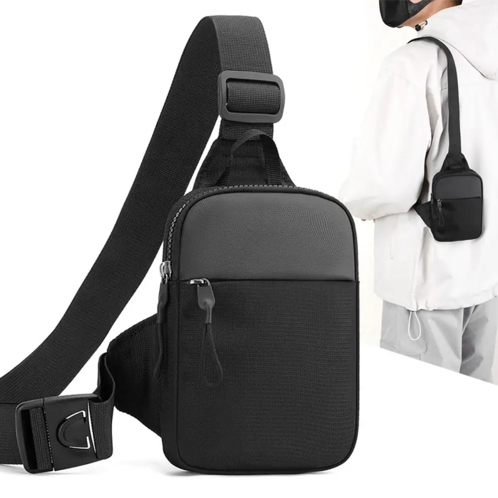 Black compact canvas crossbody sling bag worn by a person.