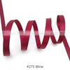 A close-up of a maroon satin ribbon with a wavy texture.