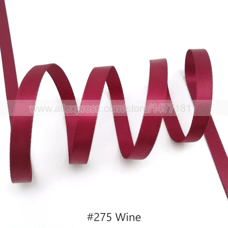 A close-up of a maroon satin ribbon with a wavy texture.