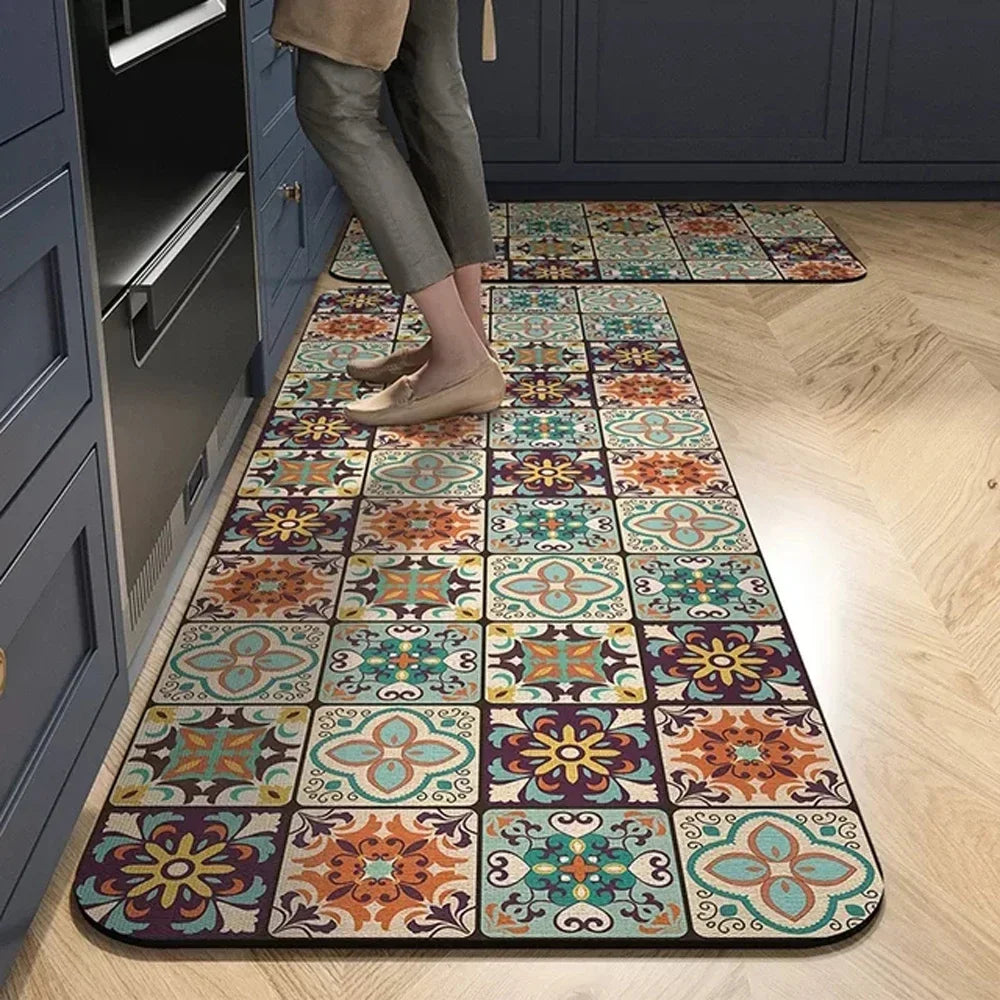A long, rectangular floor mat with a multicolored floral pattern is placed on a light wood floor in a room with dark blue cab