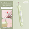 A light green needle threader tool made of ABS and stainless steel with a spring green wire.