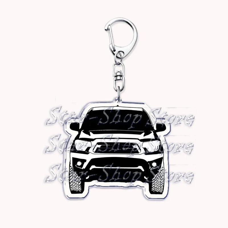 A silver metal key ring featuring a detailed model of an off-road truck.