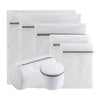 A stack of four white fine mesh laundry bags for delicates, some closed and some open.