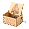 A hand-cranked wooden music box with a lid featuring a birthday candle design.
