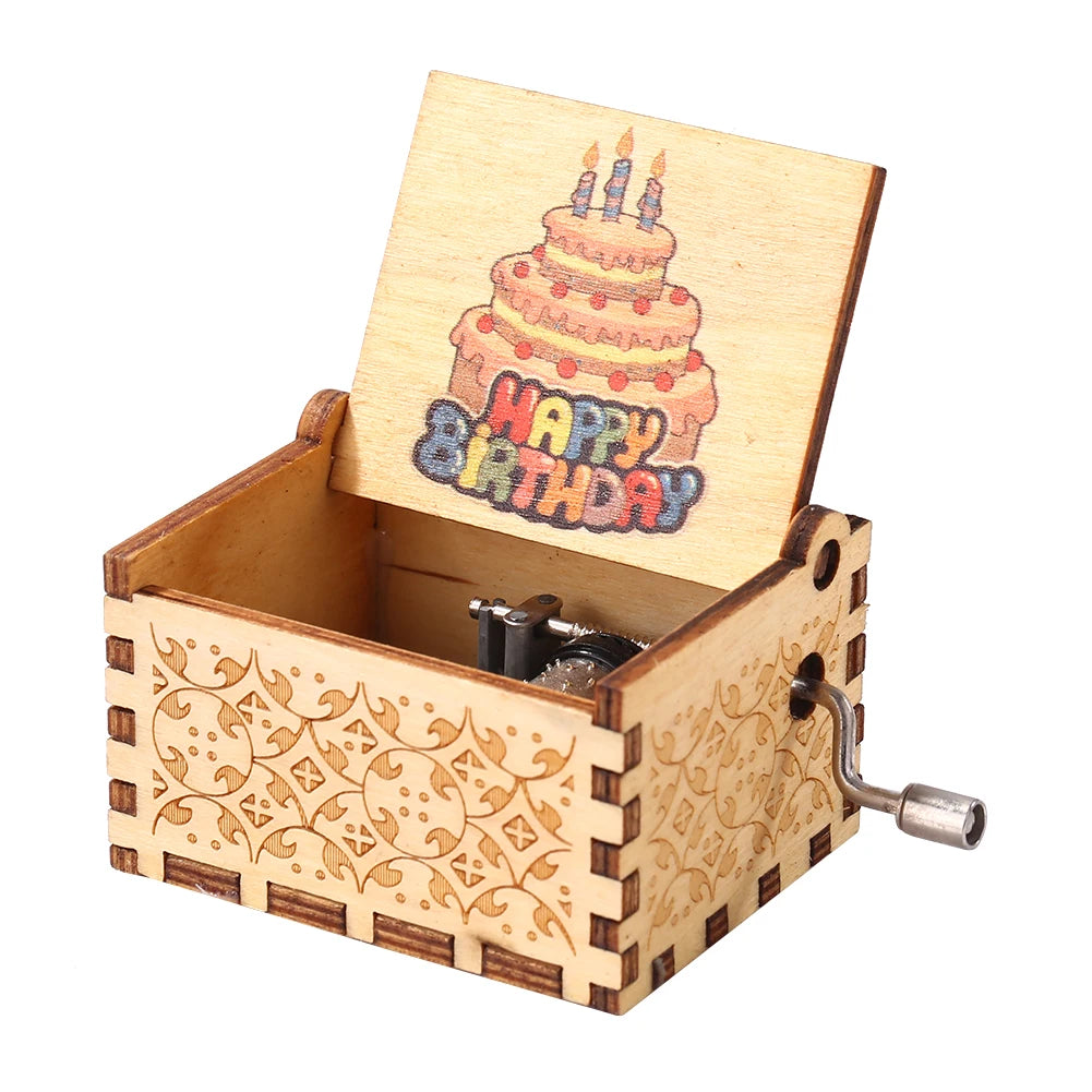 A hand-cranked wooden music box with a lid featuring a birthday candle design.