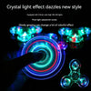 A hand is manipulating a circular LED light effect, creating colorful rings of light against a dark background.